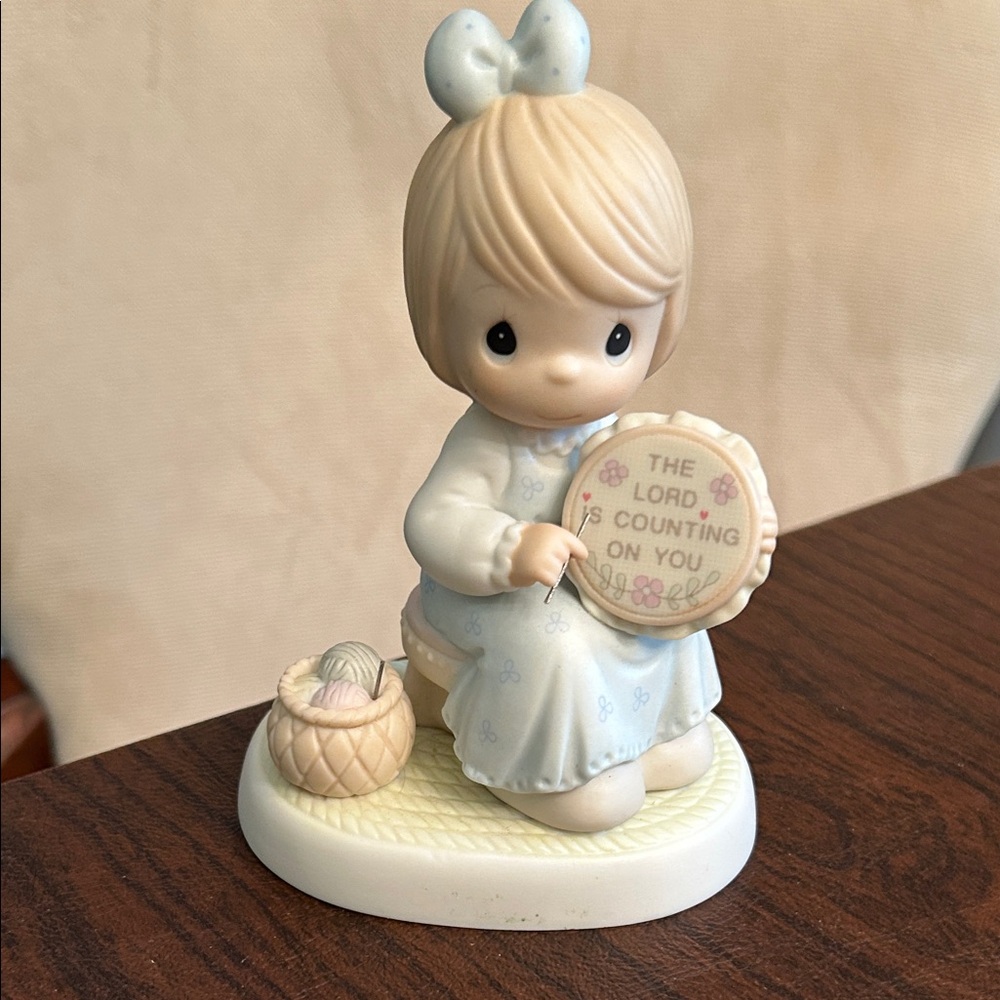 Precious Moments Porcelain Figurine with Pastel Blue Dress and Pink Bow
